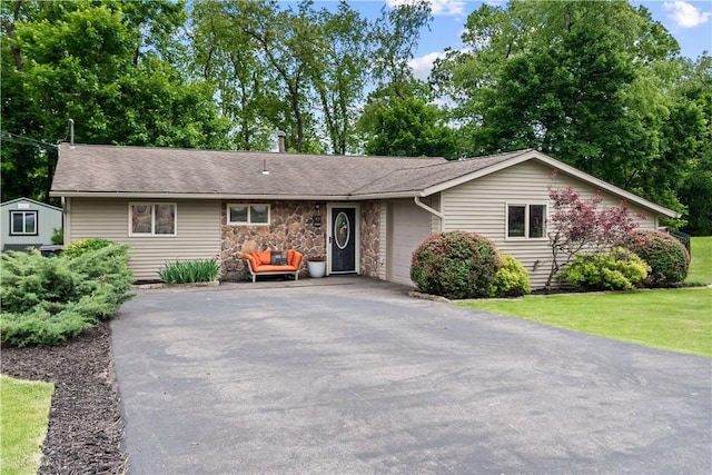 47 Dover Dr, Cranberry Twp, PA 16066 - ranch-style house featuring asphalt driveway, a garage, stone siding, a front yard, and roof with shingles