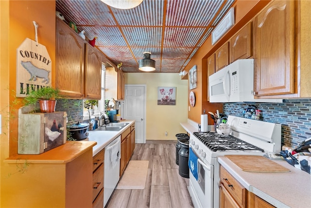 800 Romine Ave, Port Vue, PA 15133 - kitchen with white appliances, a sink, decorative backsplash, and light wood-style floors