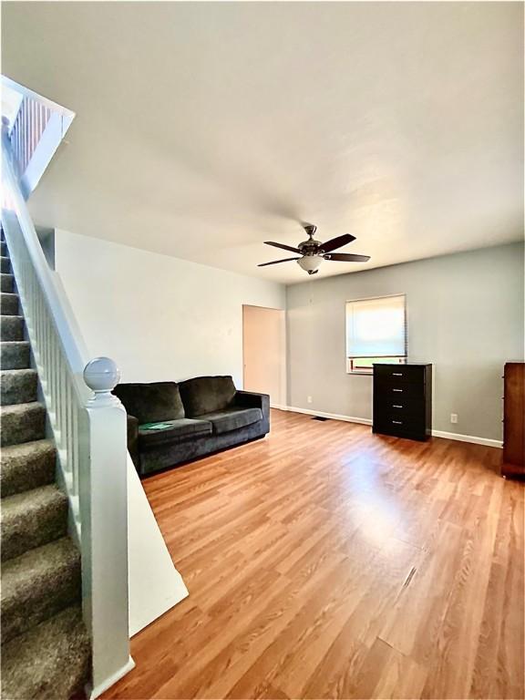 923 Fentzel, Tarentum, PA 15084 - living area featuring a ceiling fan, wood finished floors, stairway, and baseboards