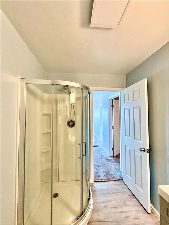 923 Fentzel, Tarentum, PA 15084 - bathroom featuring wood finished floors, a shower stall, vanity, and baseboards