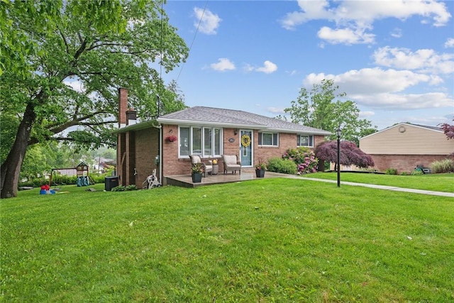 1703 Barry Dr, North Huntingdon, PA 15642 - view of front facade featuring a chimney, a front yard, and brick siding