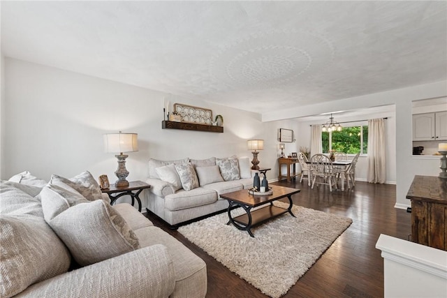 1703 Barry Dr, North Huntingdon, PA 15642 - living room featuring dark wood-type flooring, baseboards, and a chandelier