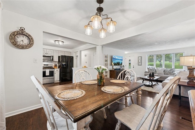 1703 Barry Dr, North Huntingdon, PA 15642 - dining room with baseboards, a chandelier, and dark wood-type flooring