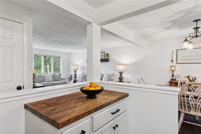 1703 Barry Dr, North Huntingdon, PA 15642 - kitchen with wooden counters, white cabinetry, open floor plan, and beam ceiling