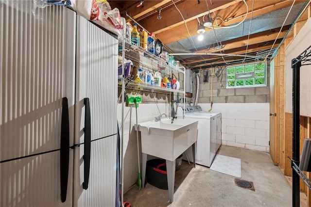 1703 Barry Dr, North Huntingdon, PA 15642 - laundry area featuring washing machine and clothes dryer and concrete block wall