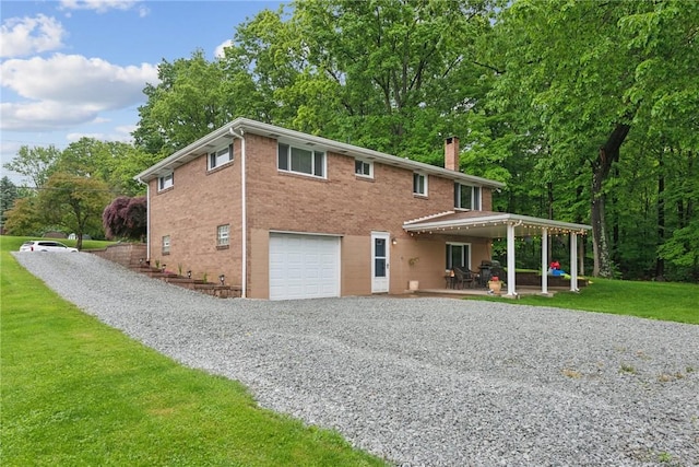 1703 Barry Dr, North Huntingdon, PA 15642 - view of front of home featuring driveway, a garage, a chimney, a front yard, and a patio
