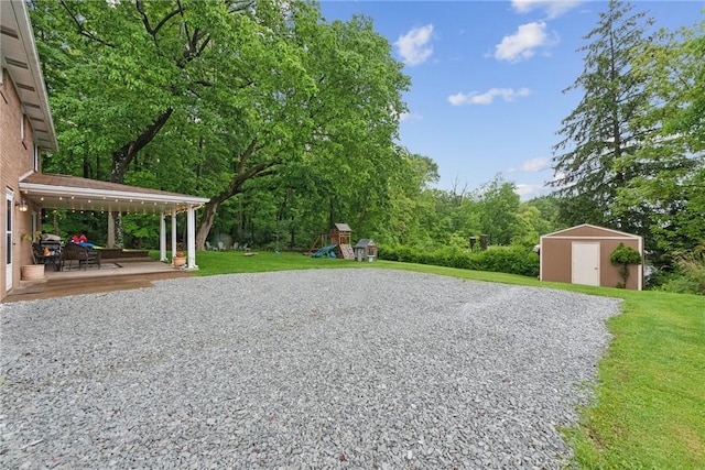 1703 Barry Dr, North Huntingdon, PA 15642 - view of grassy yard with a playground and a patio area