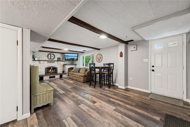 1703 Barry Dr, North Huntingdon, PA 15642 - living room with a fireplace, wood finished floors, baseboards, and beamed ceiling