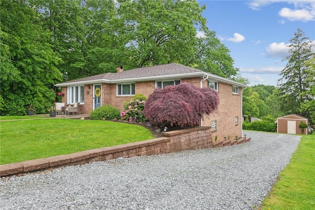 1703 Barry Dr, North Huntingdon, PA 15642 - ranch-style house featuring a chimney, brick siding, a front yard, and driveway