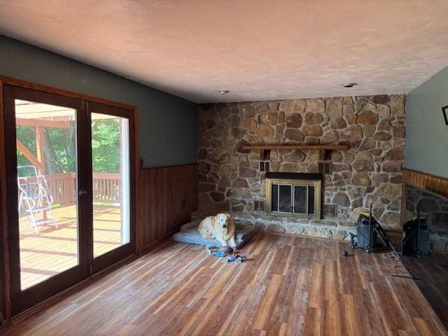 206 Brook Hollow Rd, Mount Pleasant Twp Wml, PA 15666 - unfurnished living room featuring wainscoting, wood finished floors, a fireplace, and wooden walls