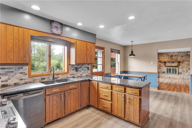 206 Brook Hollow Rd, Pa, PA 15666 - kitchen featuring a sink, dishwasher, light wood-style flooring, a peninsula, and brown cabinetry