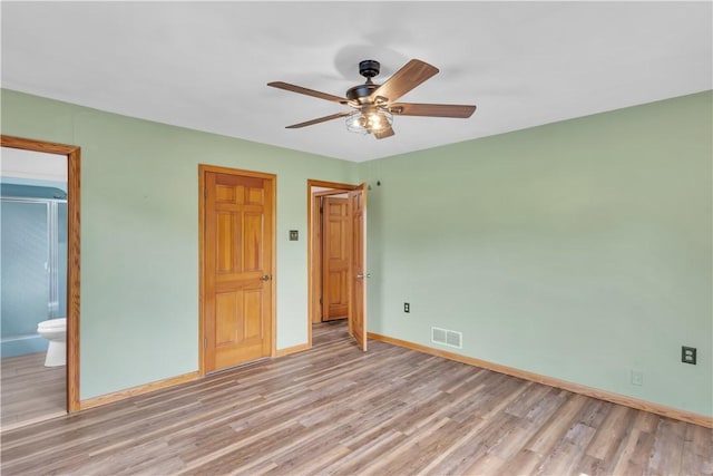 206 Brook Hollow Rd, Pa, PA 15666 - unfurnished bedroom featuring light wood-style flooring, baseboards, ensuite bath, and a ceiling fan