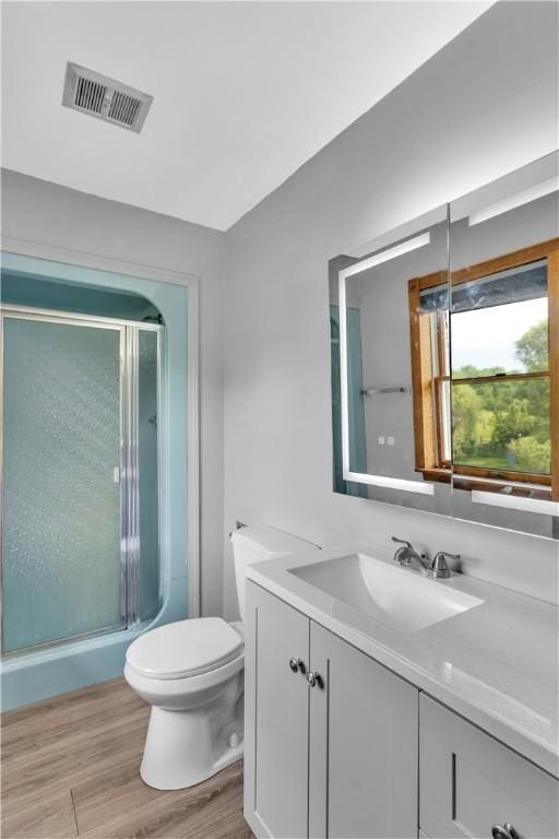 206 Brook Hollow Rd, Pa, PA 15666 - full bathroom featuring vanity, wood finished floors, toilet, and a stall shower