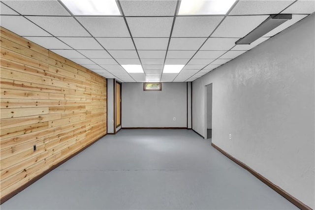 206 Brook Hollow Rd, Pa, PA 15666 - basement featuring wooden walls, a paneled ceiling, and baseboards
