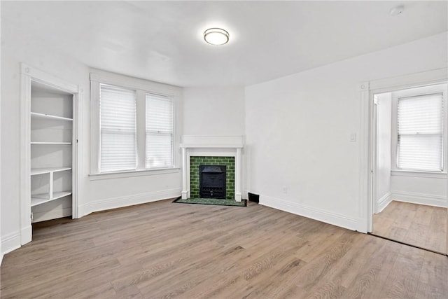 2 Elmont St, Crafton Heights, PA 15205 - unfurnished living room with wood finished floors, a tile fireplace, and baseboards