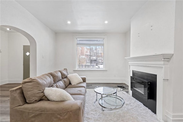 2 Elmont St, Crafton Heights, PA 15205 - living area with wood finished floors, arched walkways, baseboards, a glass covered fireplace, and recessed lighting