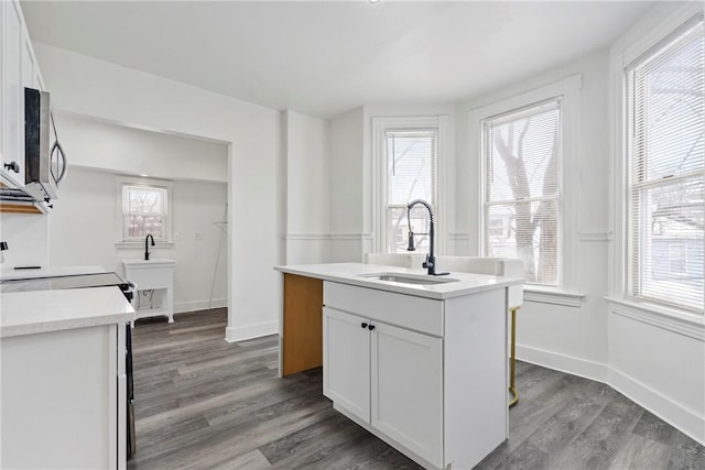 2 Elmont St, Crafton Heights, PA 15205 - kitchen with stainless steel microwave, a sink, white cabinetry, dark wood-style flooring, and baseboards