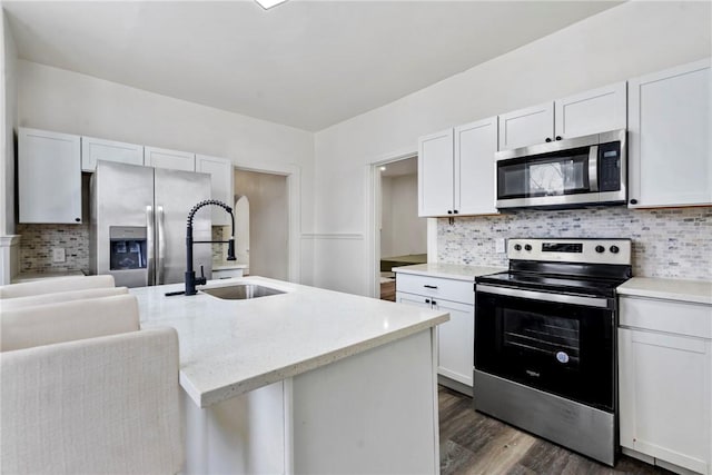 2 Elmont St, Crafton Heights, PA 15205 - kitchen featuring stainless steel appliances, a sink, decorative backsplash, dark wood-type flooring, and white cabinetry