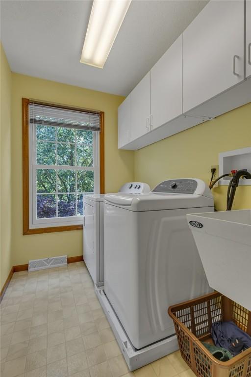 117 Bayberry Ln, Cranberry Twp, PA 16066 - laundry area with cabinet space, washer and dryer, and baseboards