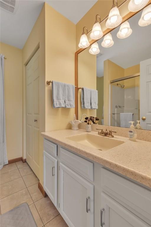 117 Bayberry Ln, Cranberry Twp, PA 16066 - bathroom featuring a stall shower, vanity, tile patterned flooring, and baseboards