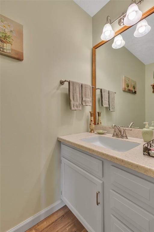 117 Bayberry Ln, Cranberry Twp, PA 16066 - bathroom featuring vanity, wood finished floors, and baseboards