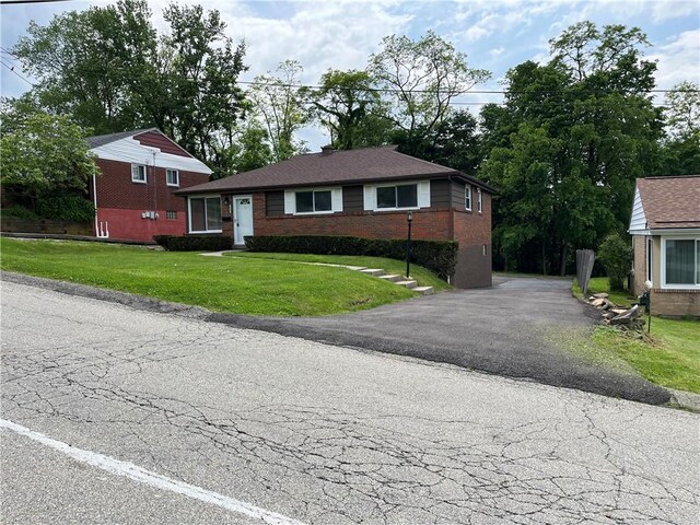 10807 Highpoint Dr, Penn Hills, PA 15235 - view of front of property with brick siding, a front yard, and driveway