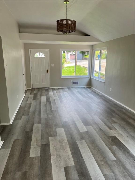 10807 Highpoint Dr, Penn Hills, PA 15235 - foyer entrance featuring a chandelier, dark wood finished floors, and baseboards