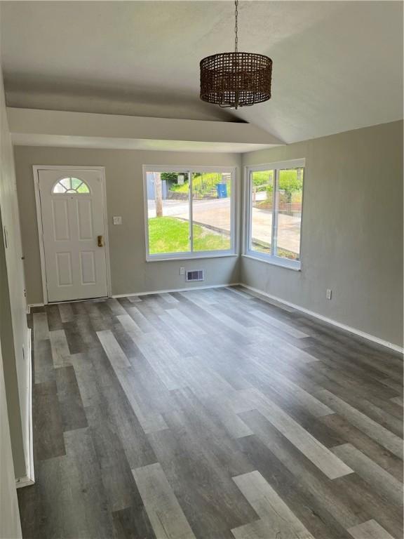 10807 Highpoint Dr, Penn Hills, PA 15235 - entryway with a chandelier, dark wood-style flooring, and baseboards