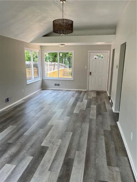 10807 Highpoint Dr, Penn Hills, PA 15235 - foyer entrance featuring dark wood-type flooring, vaulted ceiling, baseboards, and a chandelier