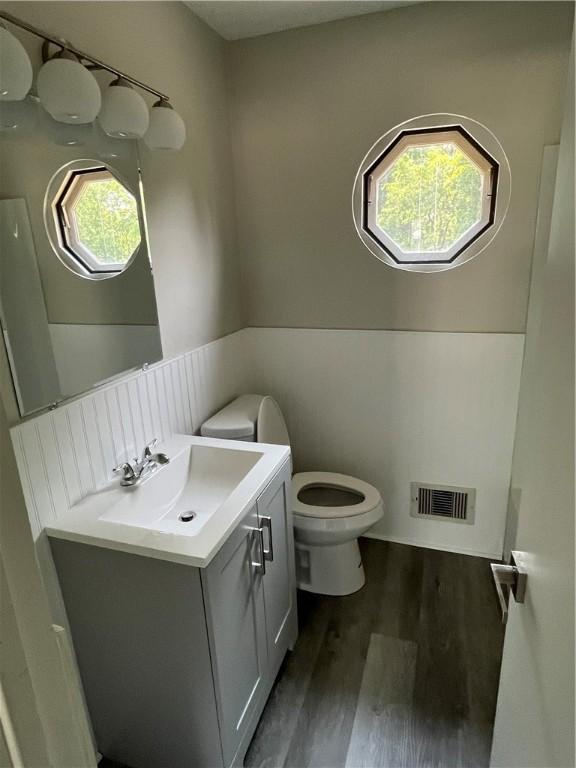 10807 Highpoint Dr, Penn Hills, PA 15235 - bathroom featuring toilet, vanity, and wood finished floors