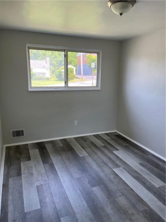 10807 Highpoint Dr, Penn Hills, PA 15235 - spare room with plenty of natural light, baseboards, and dark wood-style flooring