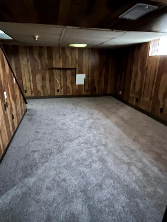 10807 Highpoint Dr, Penn Hills, PA 15235 - finished basement with wooden walls, carpet, and a drop ceiling