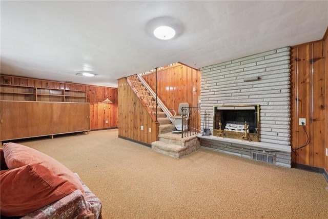 1341 Foxboro Dr, Monroeville, PA 15146 - living area with wood walls, carpet, stairway, a stone fireplace, and baseboards