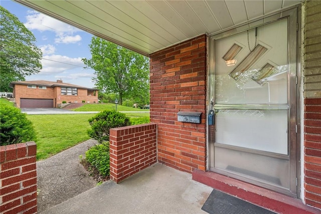 1341 Foxboro Dr, Monroeville, PA 15146 - view of exterior entry featuring covered porch, brick siding, and a yard