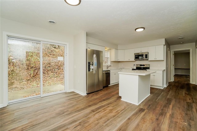 2596 Tilbrook Rd, Monroeville, PA 15146 - kitchen featuring appliances with stainless steel finishes, light countertops, white cabinetry, baseboards, and dark wood-style floors