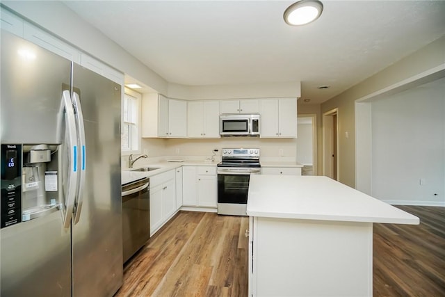 2596 Tilbrook Rd, Monroeville, PA 15146 - kitchen with stainless steel appliances, a sink, a kitchen island, and wood finished floors