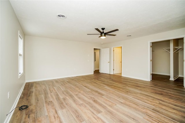 2596 Tilbrook Rd, Monroeville, PA 15146 - unfurnished bedroom with light wood-type flooring, baseboards, ceiling fan, a spacious closet, and a closet