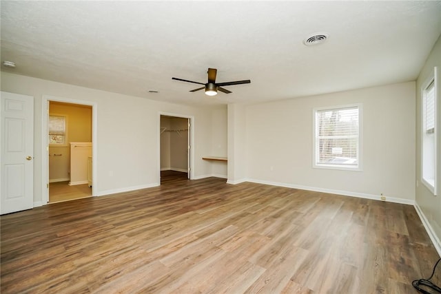 2596 Tilbrook Rd, Monroeville, PA 15146 - unfurnished bedroom with wood finished floors, baseboards, a spacious closet, ceiling fan, and a closet