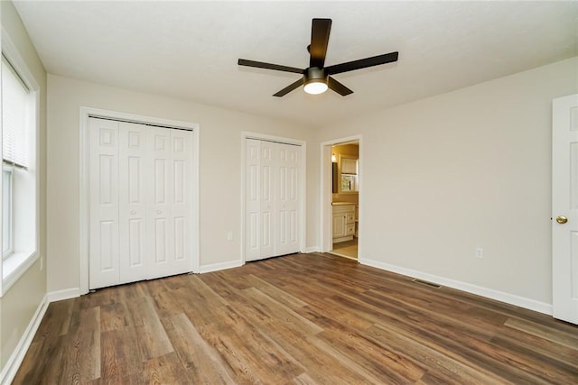 2596 Tilbrook Rd, Monroeville, PA 15146 - unfurnished bedroom with two closets, wood finished floors, baseboards, and multiple windows