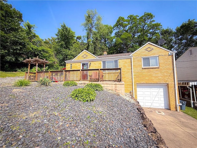 2787 Queensboro Ave, Baldwin Twp, PA 15226 - view of front of home with brick siding, an attached garage, concrete driveway, and a deck