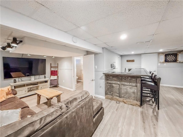2787 Queensboro Ave, Baldwin Twp, PA 15226 - living area with wood finished floors, baseboards, bar area, and a drop ceiling