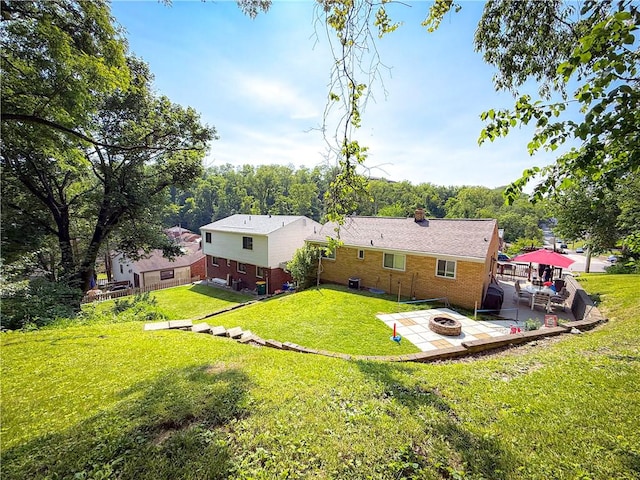 2787 Queensboro Ave, Baldwin Twp, PA 15226 - back of property featuring an outdoor fire pit, a patio area, a yard, brick siding, and a chimney