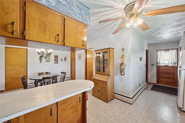178 Sagamore Rd, Cowanshanock Twp, PA 16249 - kitchen with baseboard heating, ceiling fan, light countertops, freestanding refrigerator, and brown cabinets