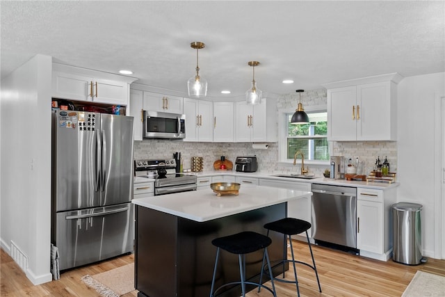 2406 Rolling Farms Rd, Shaler, PA 15116 - kitchen featuring stainless steel appliances, a sink, light countertops, white cabinetry, and recessed lighting