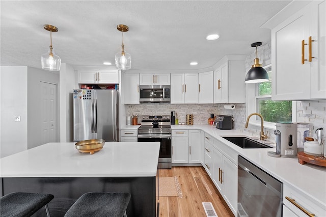 2406 Rolling Farms Rd, Shaler, PA 15116 - kitchen featuring appliances with stainless steel finishes, a sink, white cabinetry, light countertops, and recessed lighting