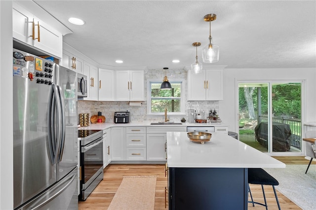 2406 Rolling Farms Rd, Shaler, PA 15116 - kitchen with stainless steel appliances, light countertops, a breakfast bar, backsplash, and white cabinetry
