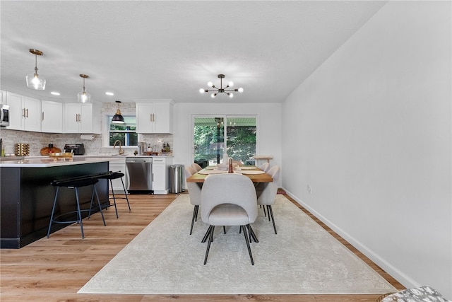 2406 Rolling Farms Rd, Shaler, PA 15116 - dining area with light wood-style floors, a chandelier, and baseboards