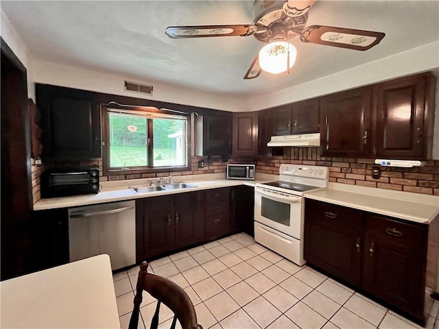 590 N Kings Creek Rd, Pa, PA 15021 - kitchen featuring stainless steel appliances, under cabinet range hood, a sink, light countertops, and backsplash