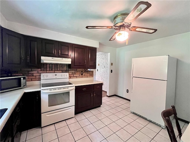 590 N Kings Creek Rd, Pa, PA 15021 - kitchen with white appliances, under cabinet range hood, light countertops, and backsplash