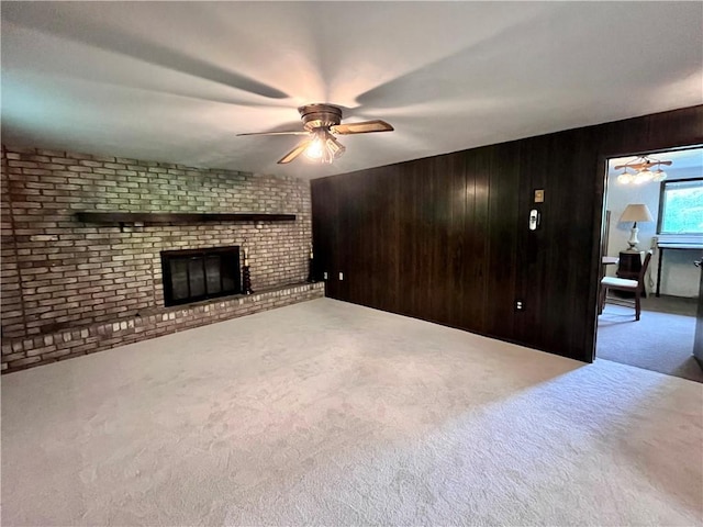 590 N Kings Creek Rd, Pa, PA 15021 - unfurnished living room featuring ceiling fan, carpet floors, a fireplace, and wooden walls